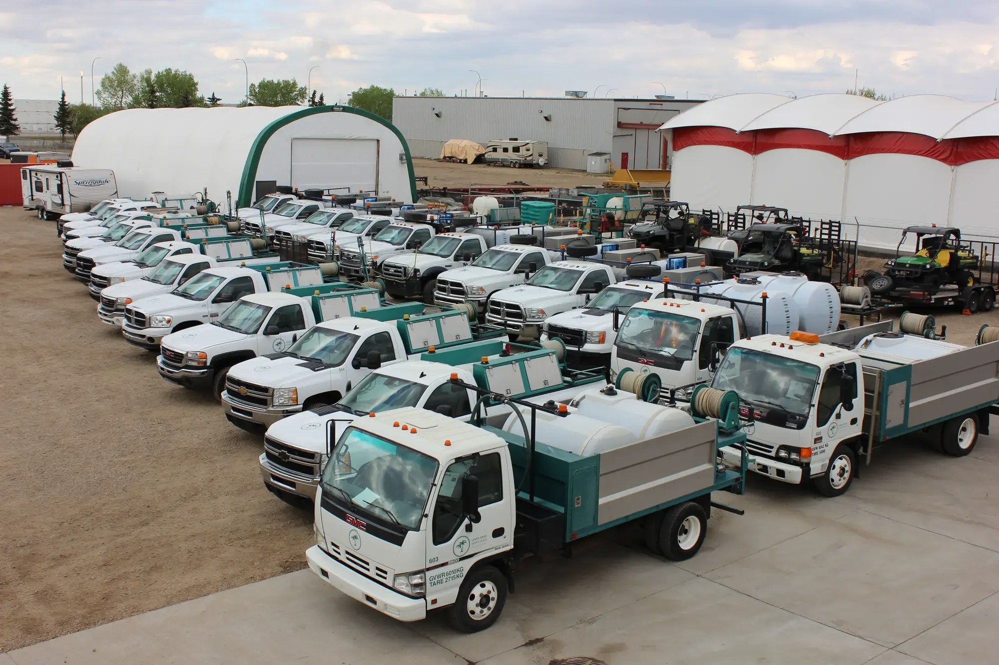 Green Oasis Services fleet of trucks and equipment at headquarters