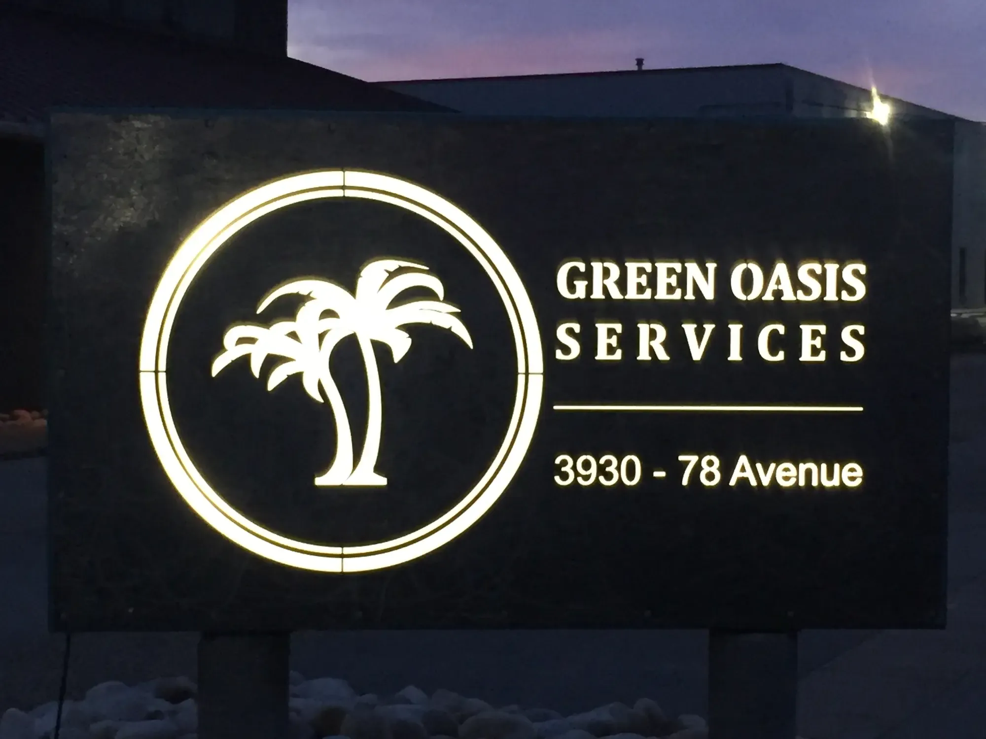 Green Oasis Services illuminated sign at headquarters
