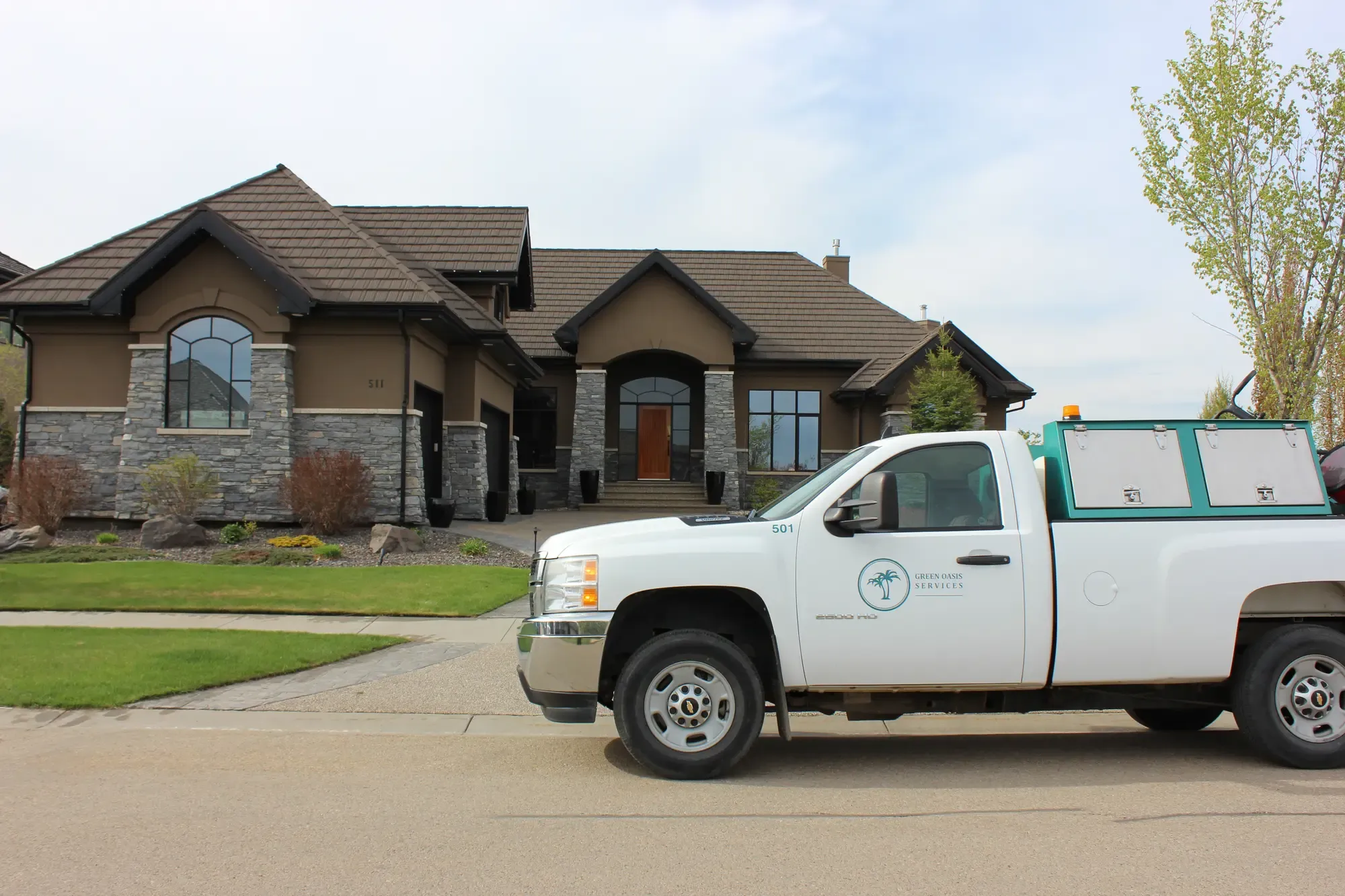 Green Oasis Services truck at luxury residential property